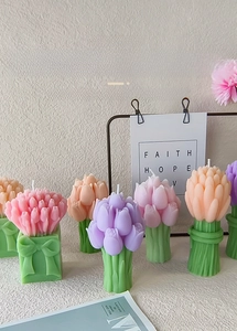 Close-up of tulip bouquet scented candles in pink and purple with bow detail