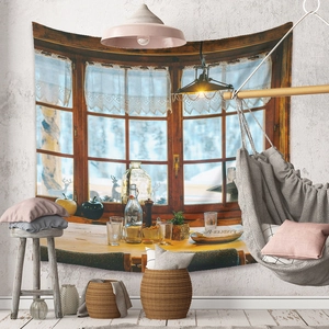 Cozy winter window scenery tapestry displayed on a textured white wall with boho decor