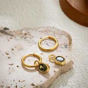 Detail of 18K gold hoop earrings with detachable oval olive green zircon pendant
