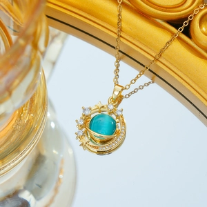 Macro shot of titanium steel necklace with blue cat-eye stone and golden star pendant