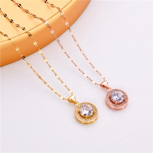 Detail shot of gold and rose gold pendant necklaces with round-cut sparkling zircon stones