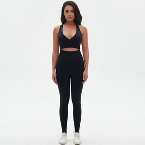 Detail of black seamless yoga set with V-neck top and cutout high-waist leggings