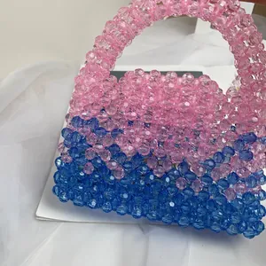 Detail showing the pink and blue translucent beaded texture of the handmade handbag