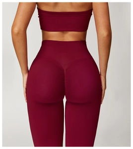Macro view of high-waist scrunch butt yoga pants in burgundy with seamless knit texture
