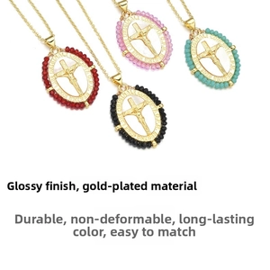Close-up of four religious cross pendants with colorful beads on 18k gold plated necklaces