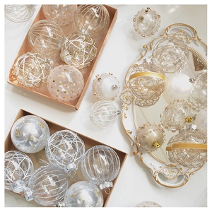 Detail of elegant champagne tulle Christmas baubles with gold glitter patterns in a box