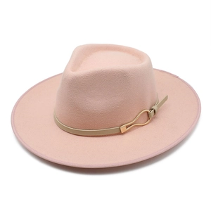Detail of light pink fedora hat featuring a tan decorative band and a golden metal buckle