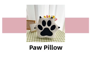 Close-up of a white plush paw bag featuring black soft claws and faux leather details