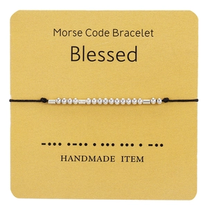 Detail of handmade Morse code bracelet with silver beads on a 'Blessed' display card