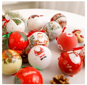 Close-up of 8cm decorative Christmas baubles with festive patterns on a pine branch