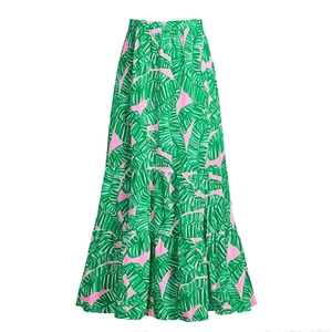 Detail of pink high-waisted maxi skirt with green tropical banana leaf print tiers