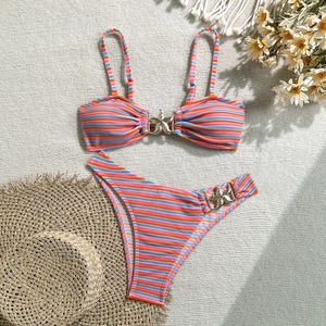 Detail of striped bikini fabric texture and decorative starfish metal buckle elements