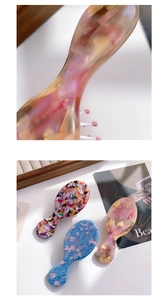 Detail of floral acetate hair combs and massage brush set in vintage French style