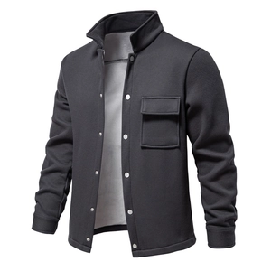 Macro view of dark grey waffle texture jacket with lapel collar and metal buttons