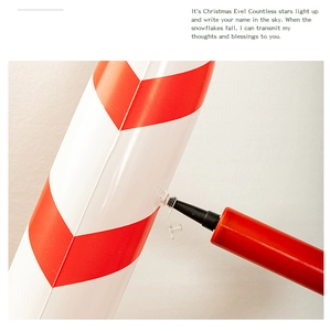 Detail showing the inflation process of a red and white striped Christmas candy cane prop