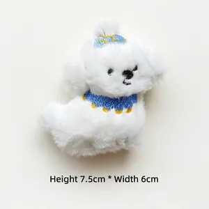 Detail of white plush dog charm with embroidered bow, size 7.5cm height by 6cm width