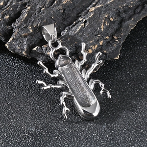 Vintage punk beetle pendant in silver stainless steel on textured dark rock
