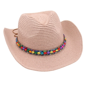 Detailed texture of beige straw cowboy hat with colorful ethnic beaded decorative band