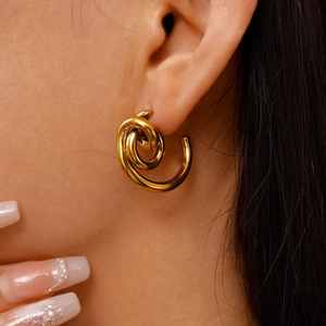 Close-up of model wearing 18k gold plated stainless steel twisted spiral earrings