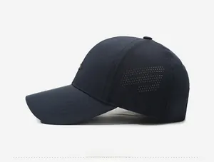 Detail of navy blue baseball cap showing laser-cut breathable holes and metal logo