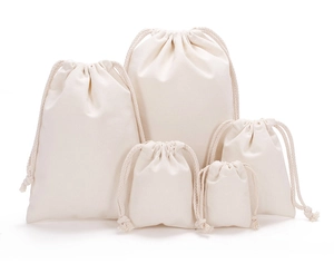 Close-up of five off-white cotton drawstring bags in various sizes for storage