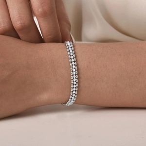 Close-up of triple-layered silver steel bracelet with shimmering white cubic zirconia