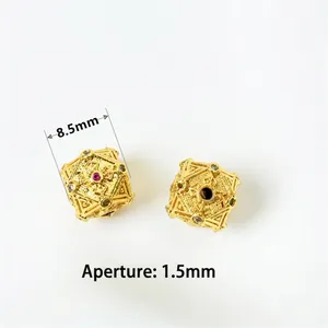 Detail of 8.5mm gold-plated beads with intricate engraving and inlaid cubic zirconia
