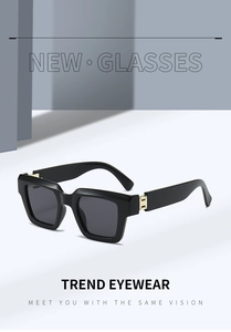 Detail of square black sunglasses featuring a signature gold H metal hinge accent