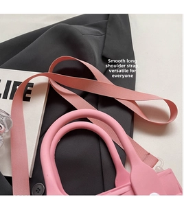 Detailed view of pink EVA crossbody bag featuring a smooth adjustable woven shoulder strap