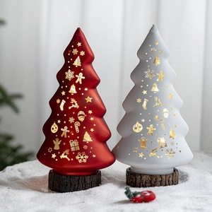 Luminous glass Christmas trees in red and white with gold snowflakes for festive decor