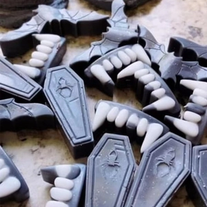 Detailed close-up of Halloween bat and coffin shaped wax melts with white vampire fangs