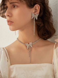 Elegant butterfly rhinestone jewelry set worn by a model with long tassels and silver finish
