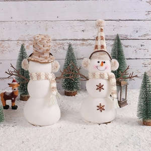 Charming plush Christmas snowmen with brown plaid hats and scarves in a winter scene