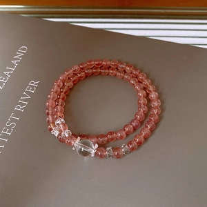 Detail of pink crystal double-strand bracelet with polished beads and metal spacers
