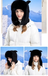 Detail of plush black winter hat with cat ears and warm earflaps in snowy scenery