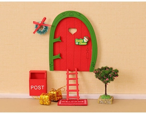 Miniature Christmas set with a red wooden door, ladder, mailbox and small festive tree