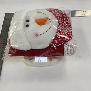 Detailed view of 3D snowman Christmas chair cover in clear packaging with measurement tool