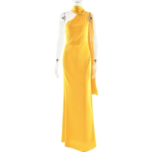 Detail of yellow satin one-shoulder dress featuring an elegant ribbon strap on the back