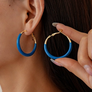 Minimalist geometric gold and klein blue hoop earrings for women with a vintage style