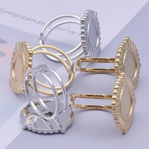 Detail showing adjustable round ring bases in gold and silver with textured edges