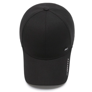 Minimalist black baseball cap with small metal badge and RNVESEV embroidery on front side