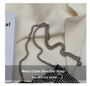 Close-up of the silver metal chain strap and sparkling black rhinestone bucket bag