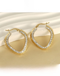Close-up of gold plated titanium steel heart earrings with crystals and Greek key pattern
