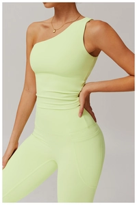 Detail of lime green one shoulder yoga tank top with high waist leggings and side pocket