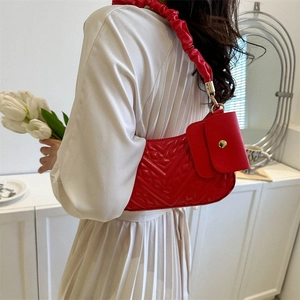 Red chevron quilted shoulder bag with ruched strap and matching coin purse on model