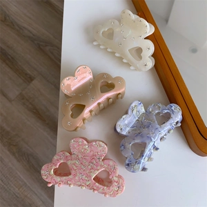 Macro shot of assorted acetate hair claws with rhinestone details and heart cutout