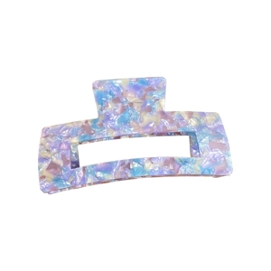 Classic oversized acetate hair claw clip with purple marble pattern on white background