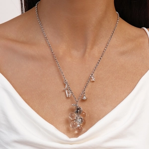 Close-up of star and grape glass bead charms on a silver-toned necklace for women