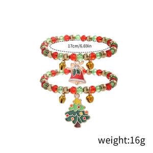 Detailed view of red and green beaded Christmas bracelets with tree and bell charms