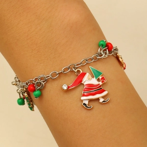 Detailed close-up of a Christmas charm bracelet with Santa and tree motifs on a wrist